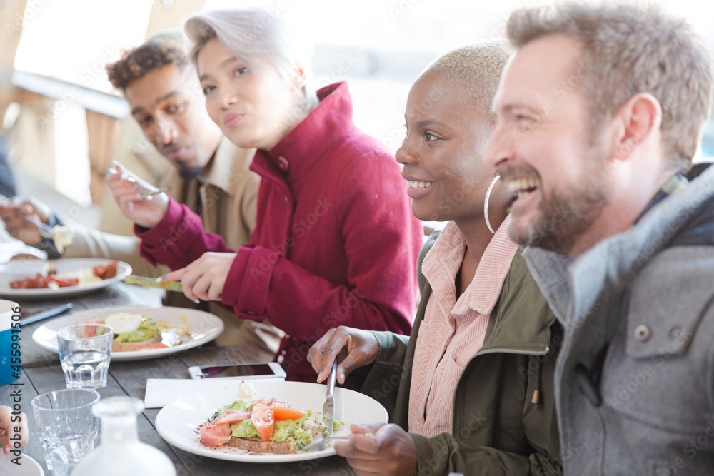 Portrait of smiling friends eating at restaurant outdoor patio Portrait of smiling friends eating at restaurant outdoor patio