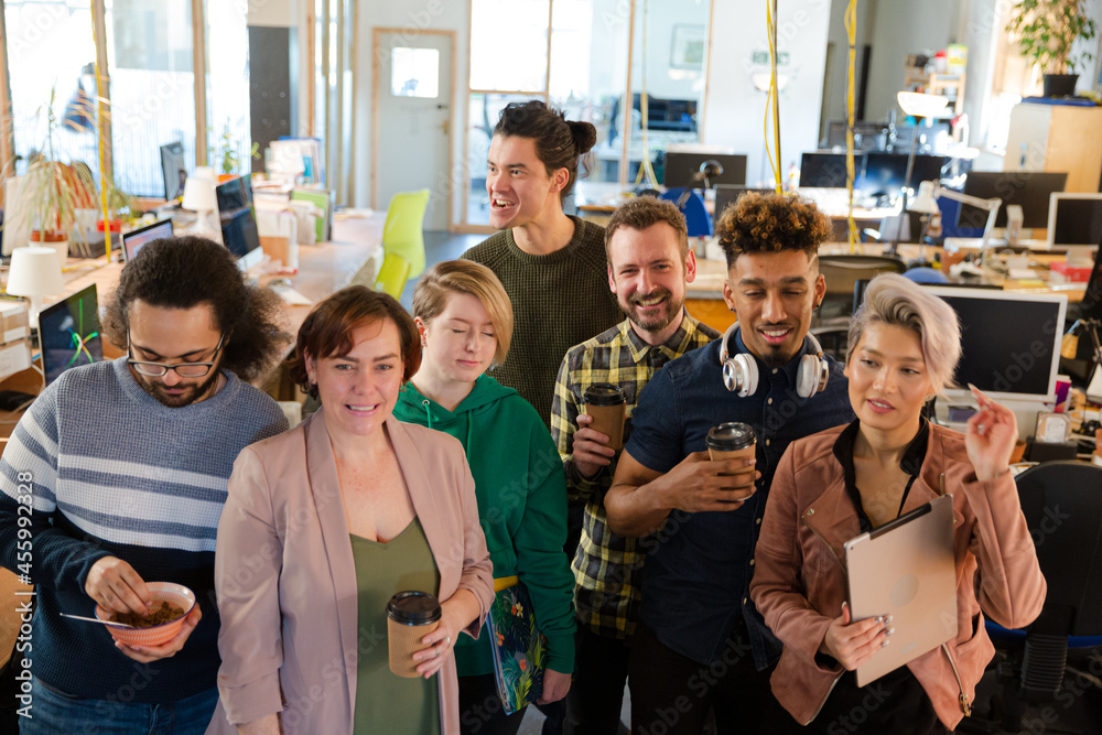 Team posing in office, smiling