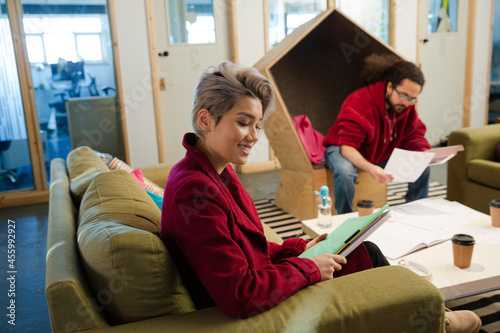 Man and woman reviewing paperwork in cosy office