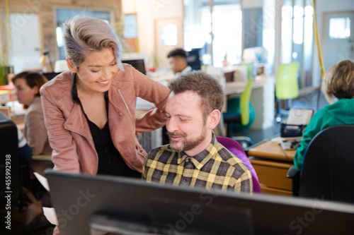 Man and woman discussing paperwork at desk