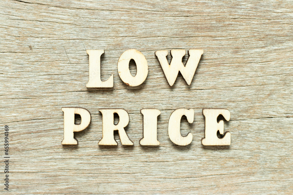 Alphabet letter in word low price on wood background Alphabet letter in word low price on wood background