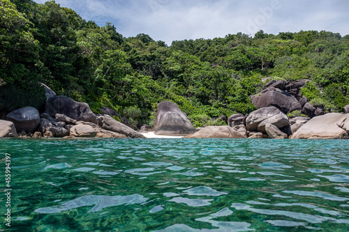 Similan islands with natural rocks on coastline in tropical sea on sunny day