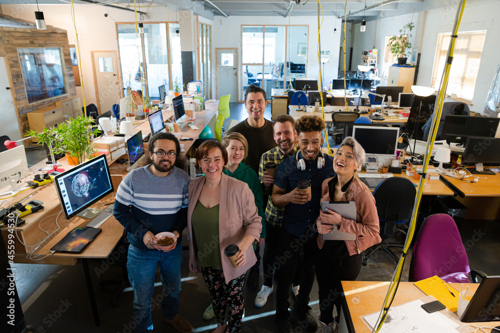 Team posing in office, smiling Team posing in office, smiling