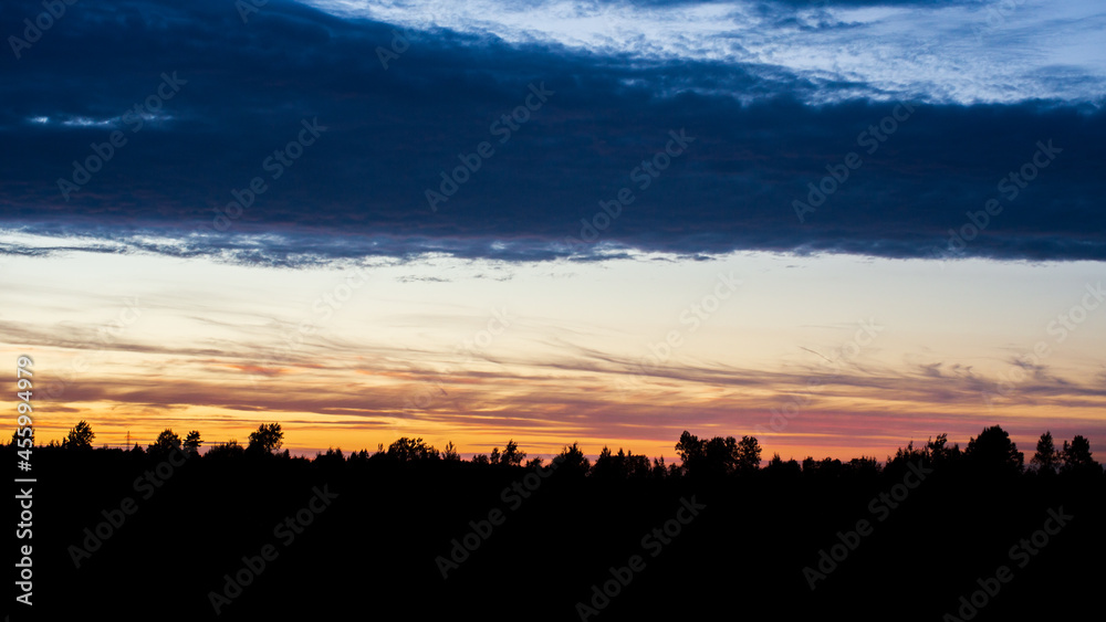 Sunset with the silhouette of the forest