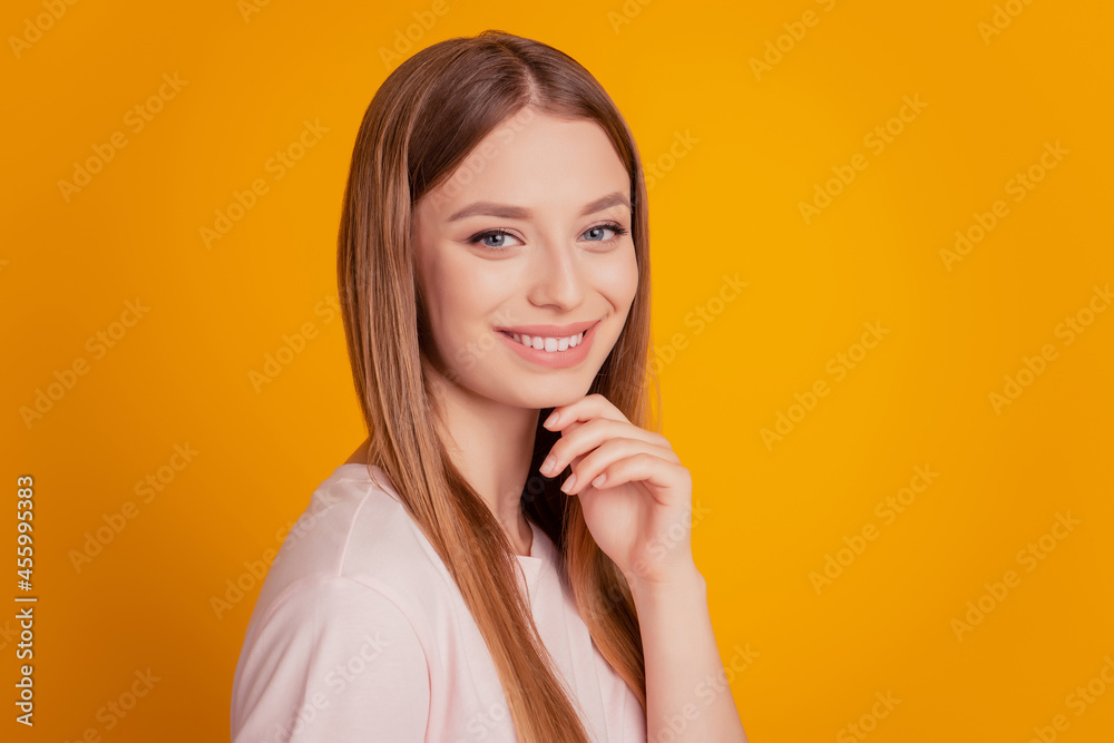 Portrait of cheerful nice smart shiny lady finger chin on yellow background Portrait of cheerful nice smart shiny lady finger chin on yellow background