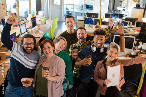 Team posing in office, smiling