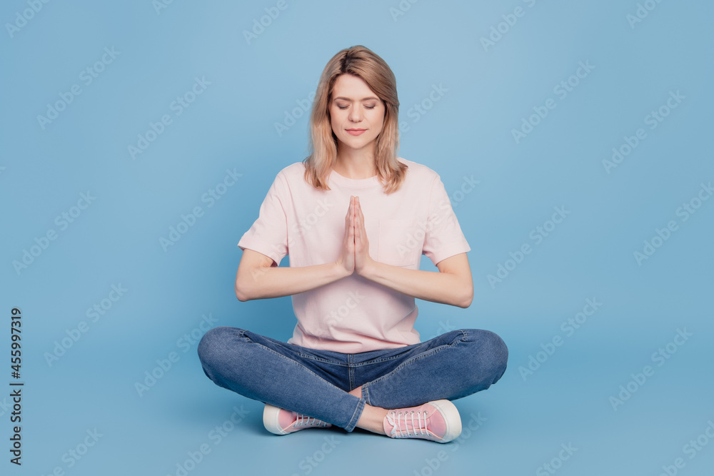 Portrait of charming fit lovely lady sit floor yoga practice concept on blue background Portrait of charming fit lovely lady sit floor yoga practice concept on blue background