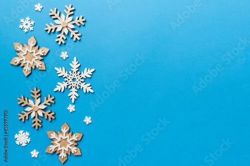 New Year composition white christmas snowflakes. Christmas decor background with pine cones. Top view with copy space