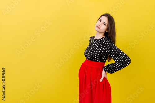 Pregnant woman with a pain in her back on colored Background isolated © sosiukin
