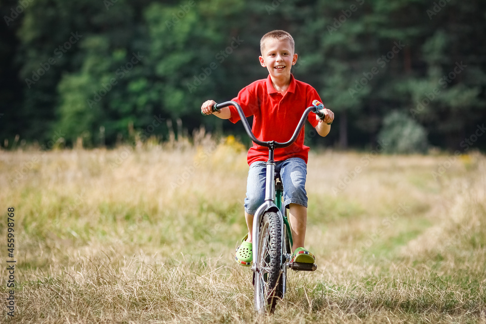 A Happy child cycling in the park concept in nature