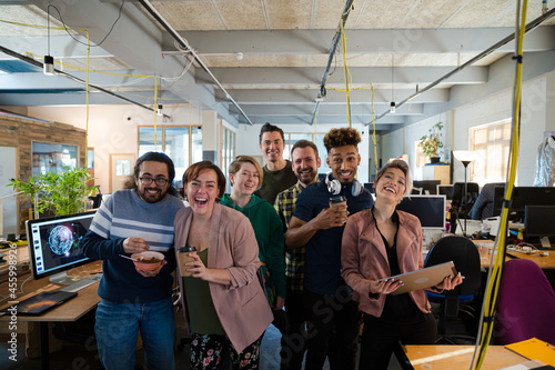 Team posing in office, smiling