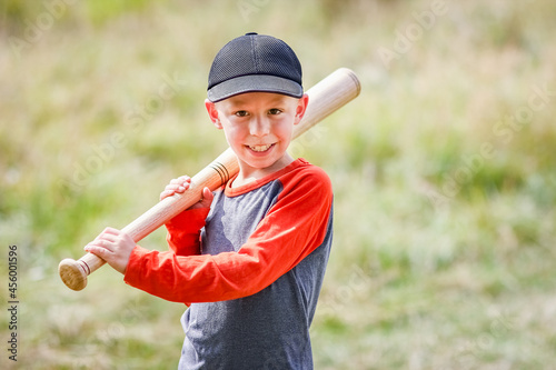 Wall Mural A Happy child with baseball bat on nature concept in park