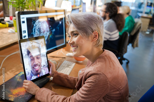 Young woman using tablet computer at desk