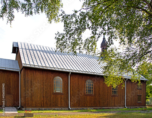 General view and architectural details of the belfry and the wooden Catholic church of St. Andrew Bobola built in 1938 in the village of Skierkowizna in Mazovia, Poland. photo