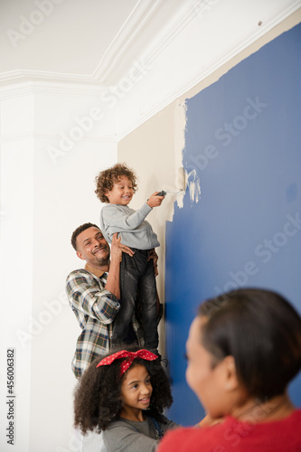 Happy family painting wall