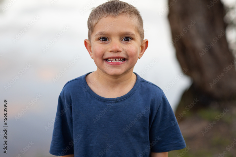 five year old boy grinning at camera five year old boy grinning at camera