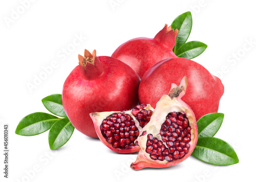 Ripe sweet fruits of pomegranate and pomegranate slices with green leaves isolated on white background.
