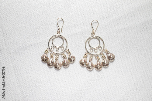 Antique real silver earring on white cloth background