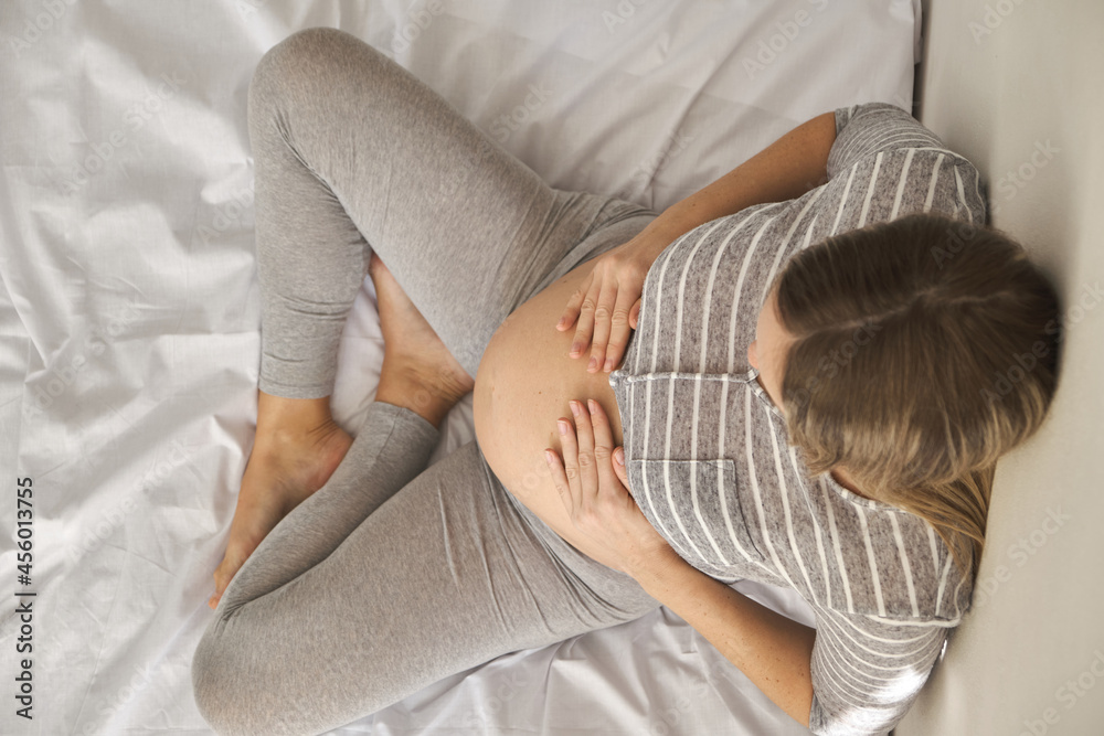 Happy pregnancy and maternity concept. Top view of young Caucasian woman Happy pregnancy and maternity concept. Top view of young Caucasian woman