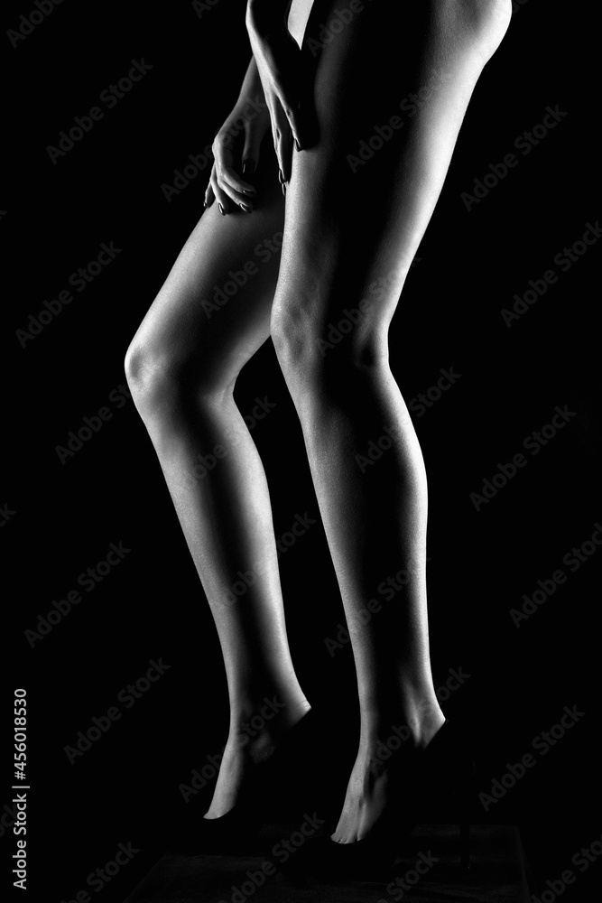 female legs in high heels shoes. girl silhouette in the dark female legs in high heels shoes. girl silhouette in the dark