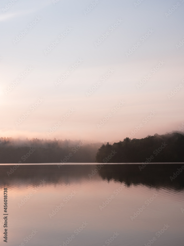Foggy sunrise on a lake in the forests of New Hampshire