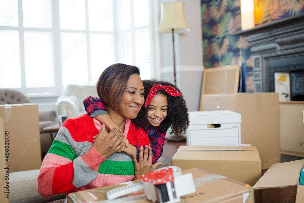 Mother and child hugging in living room Mother and child hugging in living room