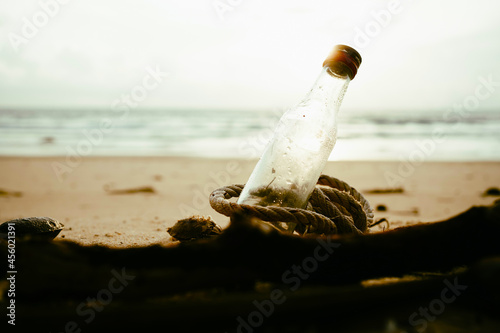 Plastic water bottles pollution on beach sunset.Empty used dirty plastic bottles.