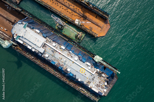 Roll-on Roll-of ship repairing and maintenance on shipyard Industry in green sea aerial top view. © SHUTTER DIN