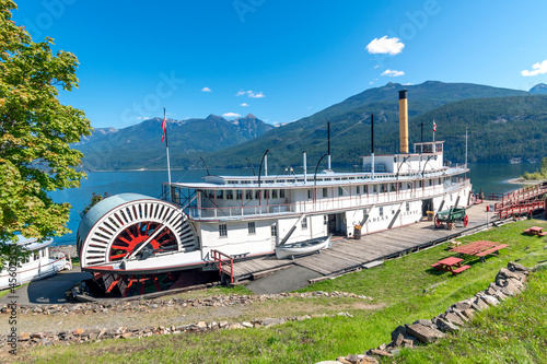 A vintage paddle steamer sternwheeler sits in the bay at Kootenay Lake at the Moyie Sternwheeler National Historic Site in the village of Kaslo. photo