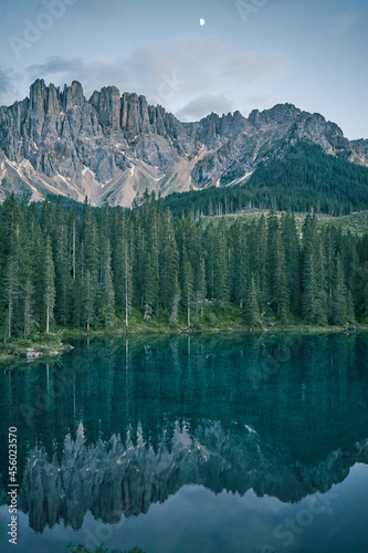 Crystal water of Lake Carezza (Karersee) in Dolomite Alps, Trentino Alto Adige, South Tirol, Italy at daytime © Роман Мельник