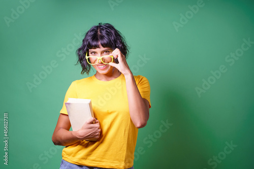 Young girl holding book and spectacles © Lomb