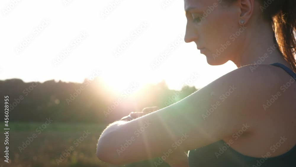 Sports woman monitors her health and uses a smart watch. Woman hand touching smart watch. Smart watch.