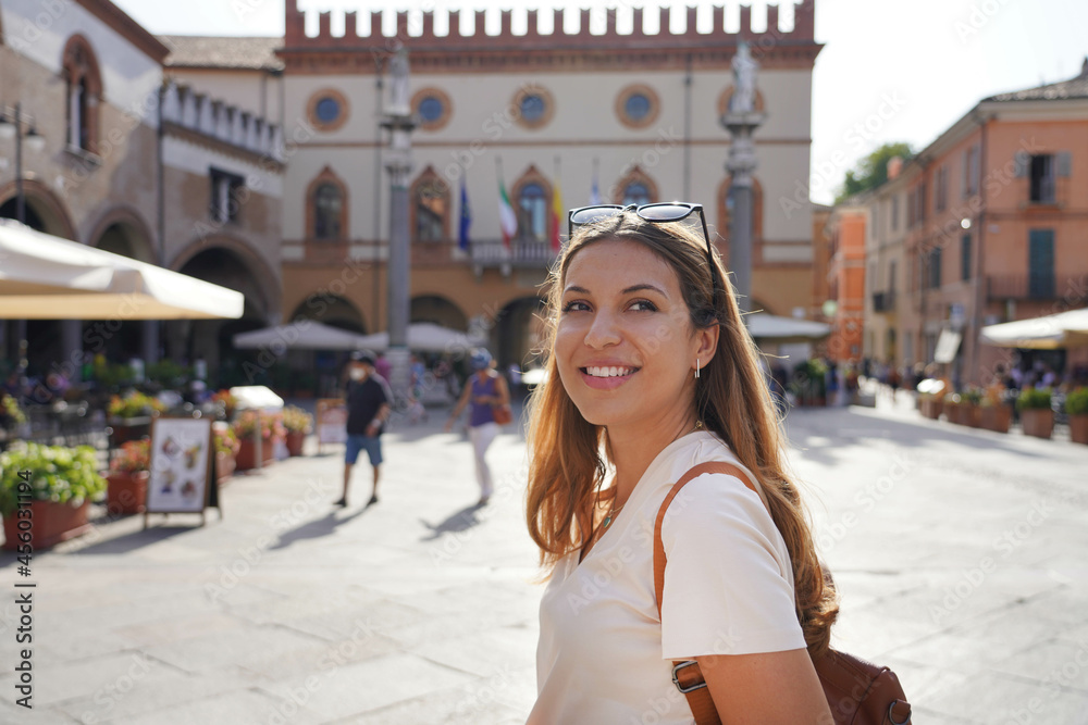 Portrait of beautiful stylish woman doing cultural visit of medieval old town, Ravenna, Italy