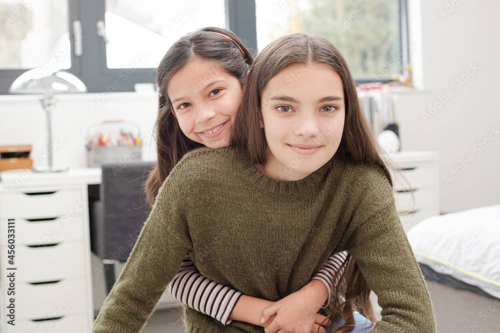 Portrait smiling sisters in room Portrait smiling sisters in room