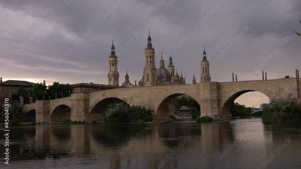 Cathedral Basilica of Our Lady of Pillar with bridge and the Ebro river at sunset. A Roman Catholic church in the old city center of Zaragoza. Landmark monument of Aragon region at north of Spain-Dan Cathedral Basilica of Our Lady of Pillar with bridge and the Ebro river at sunset. A Roman Catholic church in the old city center of Zaragoza. Landmark monument of Aragon region at north of Spain-Dan