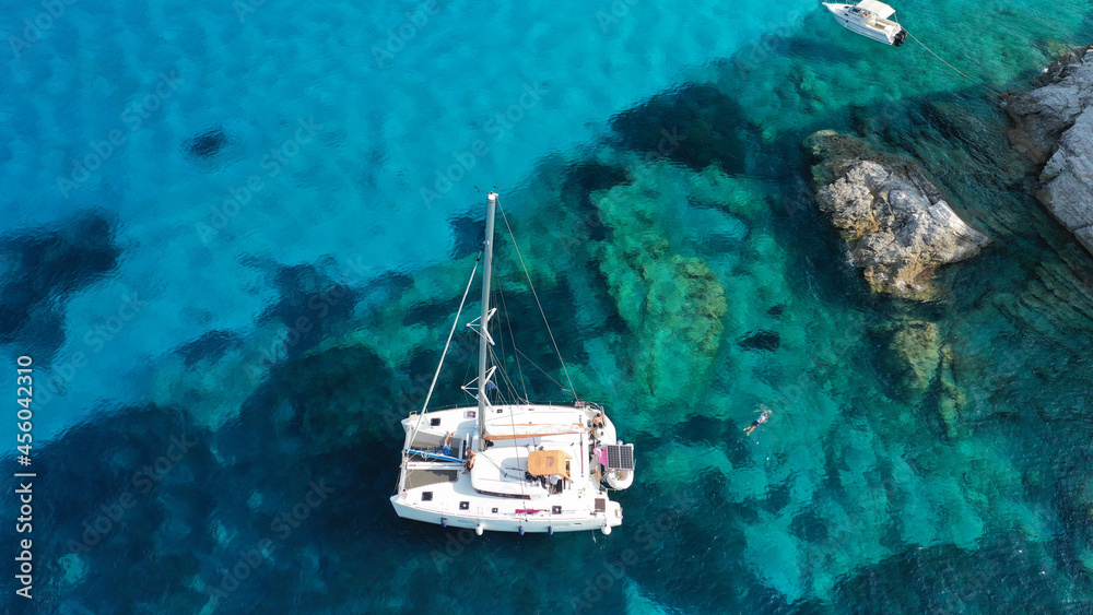 Aerial drone photo of beautiful catamaran sailing yacht anchored in tropical exotic turquoise sea exotic bay