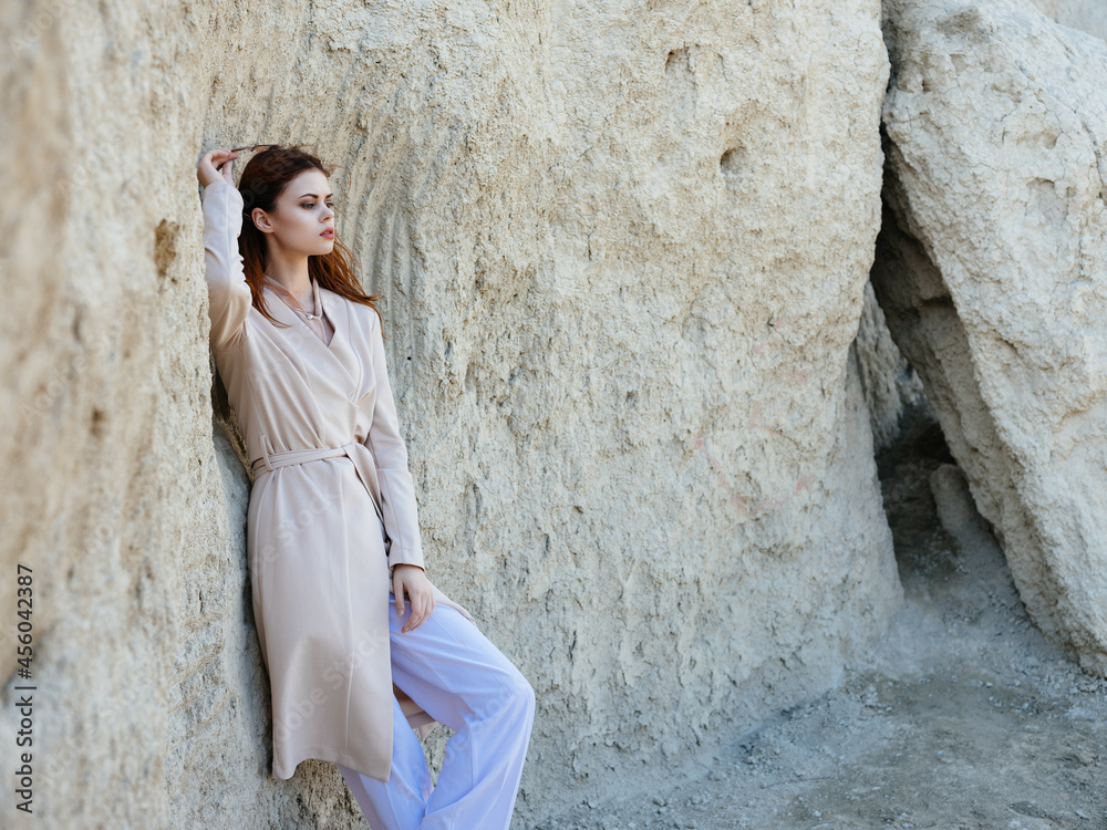 beautiful woman posing near rocks in the sand lifestyle fashion beautiful woman posing near rocks in the sand lifestyle fashion