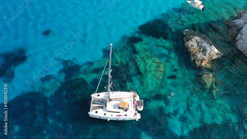 Leinwand Poster Aerial drone photo of beautiful catamaran sailing yacht anchored in tropical exo