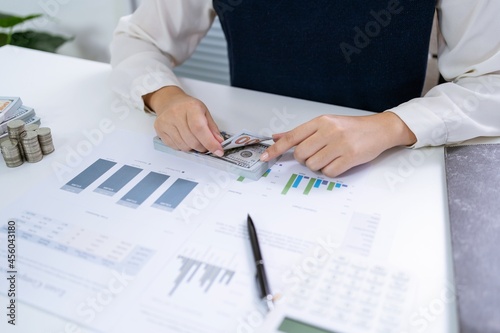 Businesswoman Accountant analyzing investment charts Invoice and pressing calculator buttons over documents. Accounting Bookkeeper Clerk Bank Advisor And Auditor Concept
