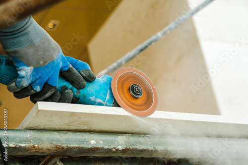 hand holding mansionry machine to polish marble stone. photo