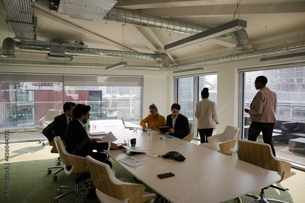 Business people leaving conference room after meeting