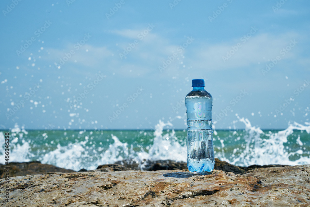 Plastic bottle. Coast of the sea. Waves hit the stones. Plastic bottle. Coast of the sea. Waves hit the stones.