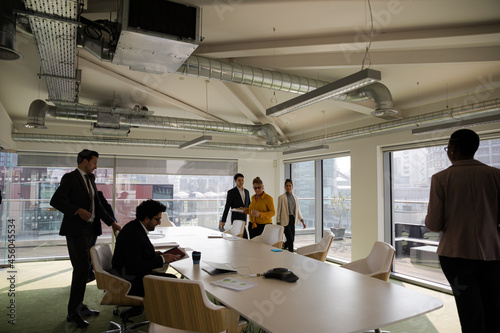 Business people leaving conference room after meeting