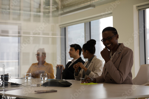 Smiling businesswoman in conference room meeting