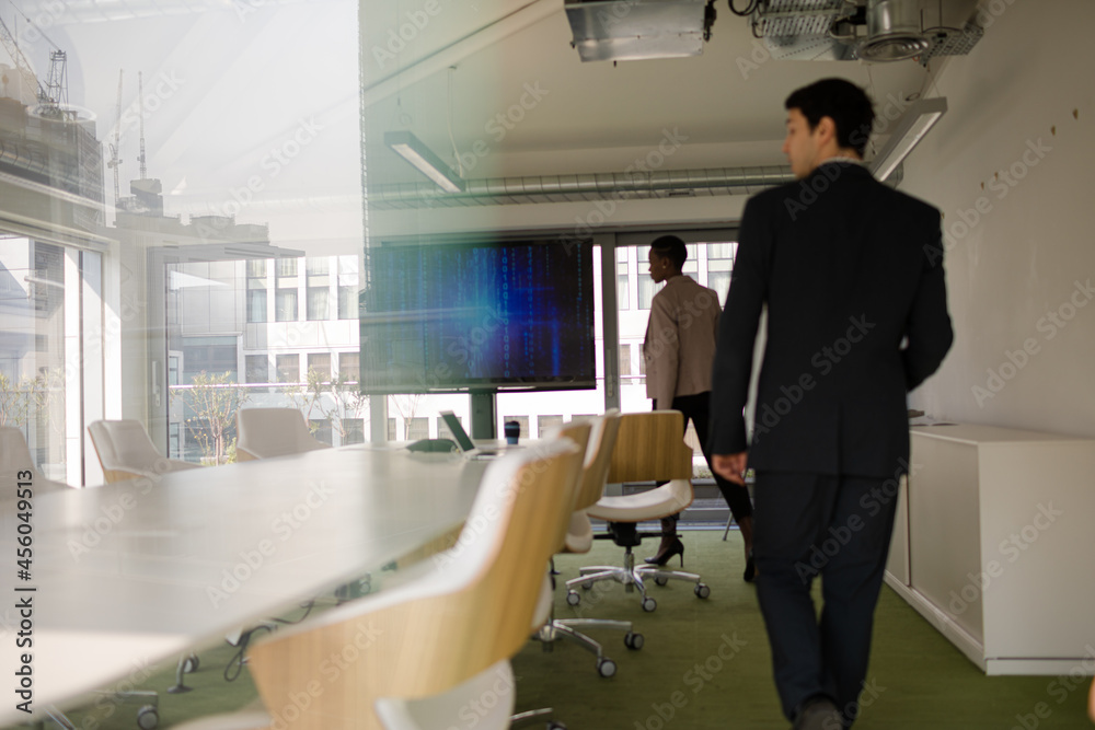 Business people leaving conference room Business people leaving conference room