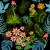 Seamless pattern with bright flowers and tropical leaves of palm tree on black background.