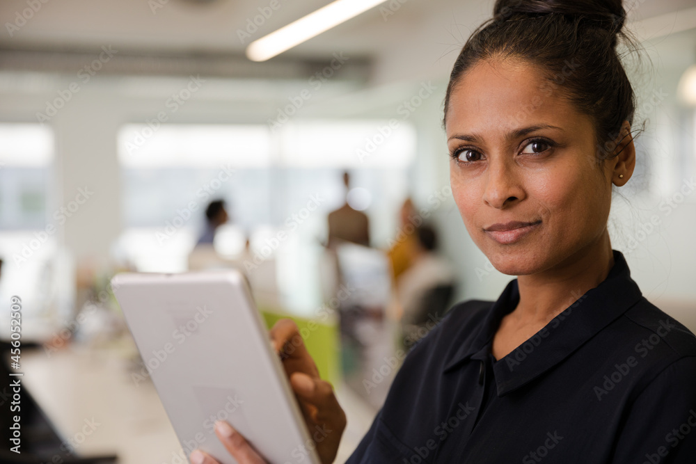 Portrait of confident businesswoman in open plan office Portrait of confident businesswoman in open plan office