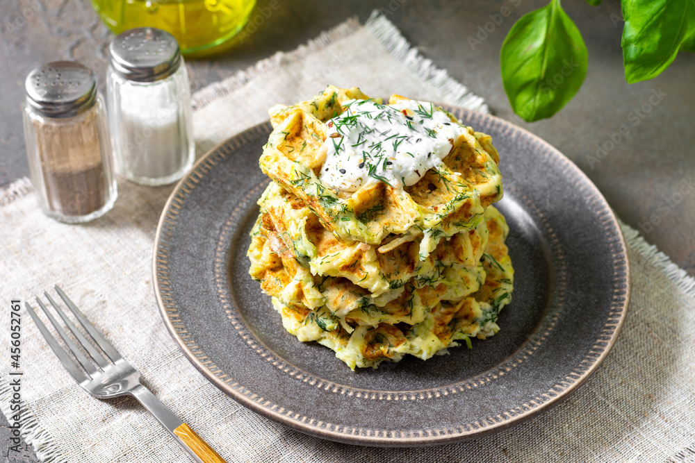 Homemade zucchini waffles in a plate on a culinary background closeup Homemade zucchini waffles in a plate on a culinary background closeup