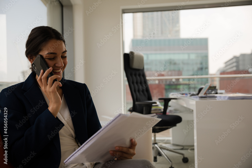 Portrait of businesswoman using smartphone in office Portrait of businesswoman using smartphone in office