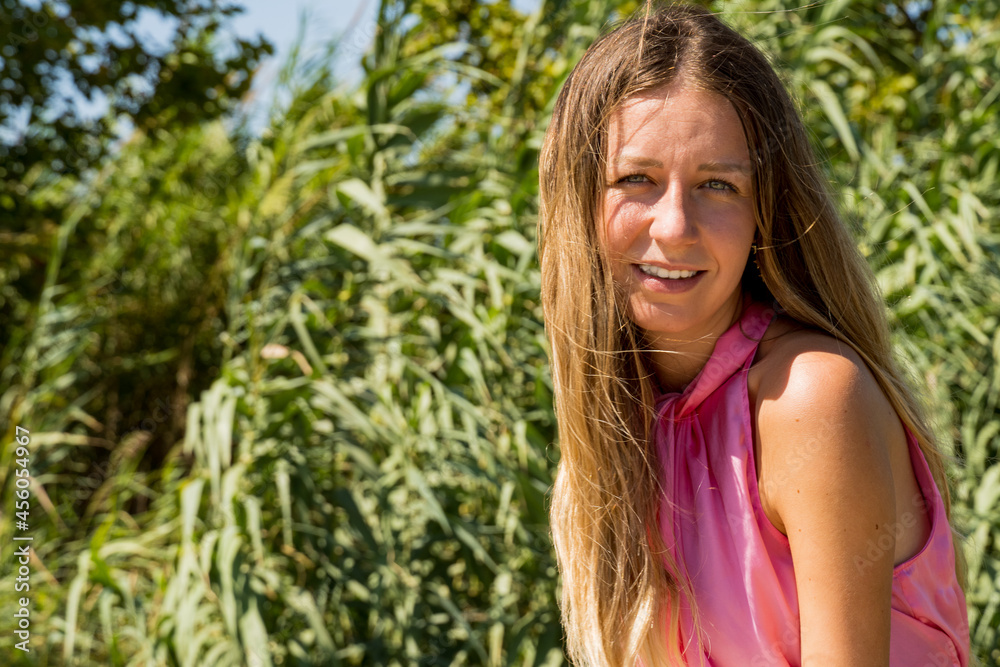 Portrait of a young caucasian girl wearing a pink top smiling Portrait of a young caucasian girl wearing a pink top smiling